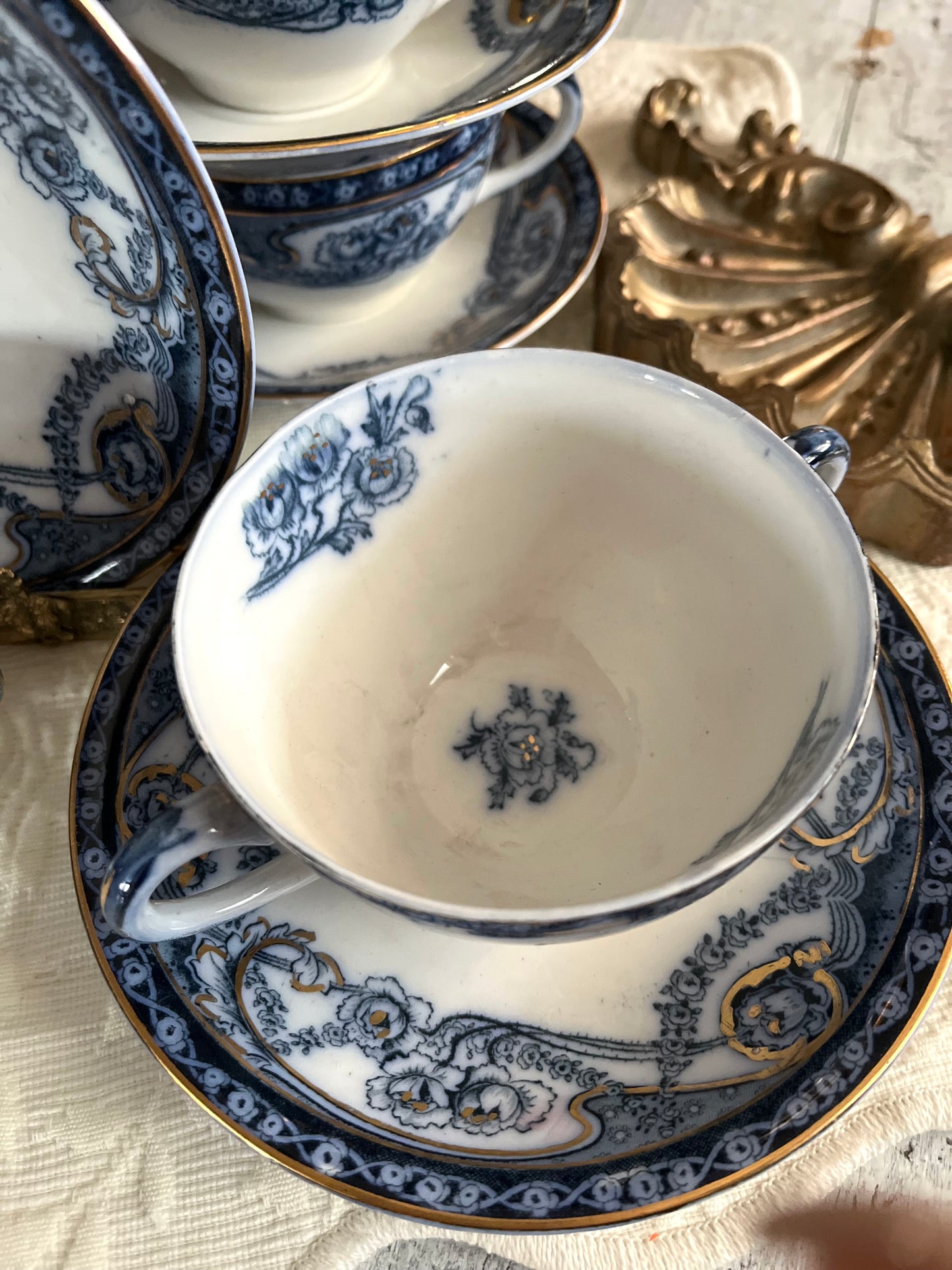Romantic Set of 6/19th Century Royal Staffordshire “Reknown” Flow Blue Gilded Broth Cups and Saucers