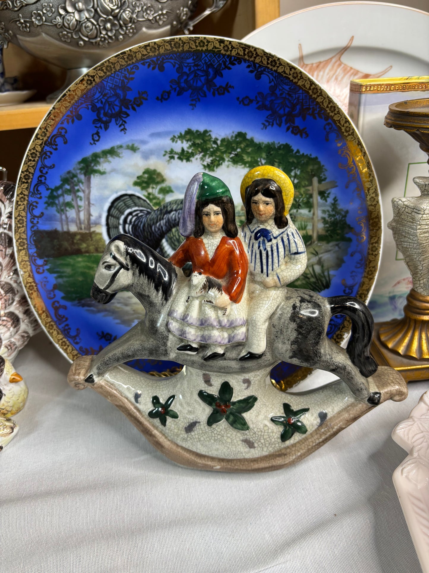 Staffordshire couple on rocking horse!