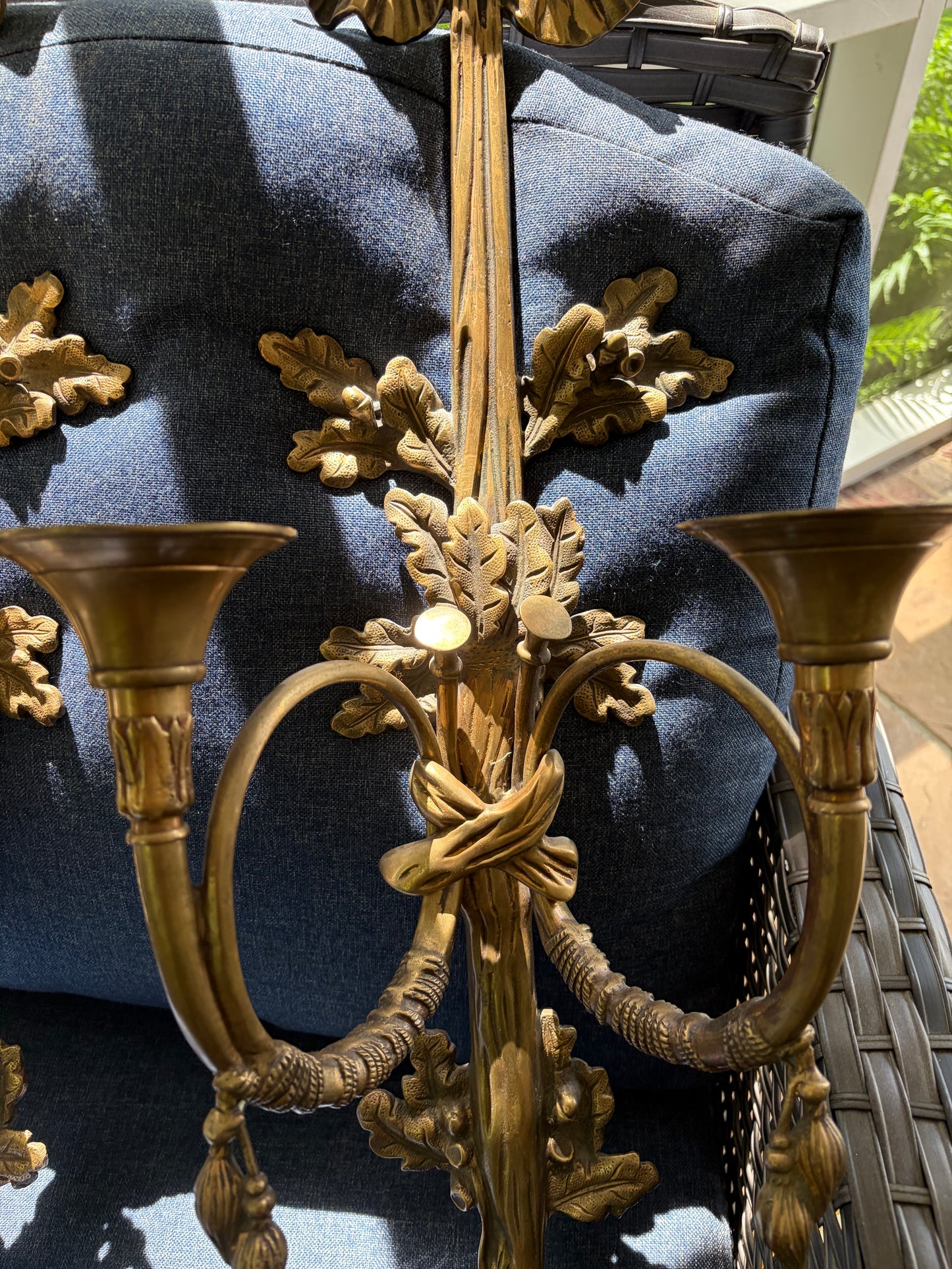 Stunning antique pair of French Louis XVI style brass wall sconces with bows, tassels, and horn motif designs!