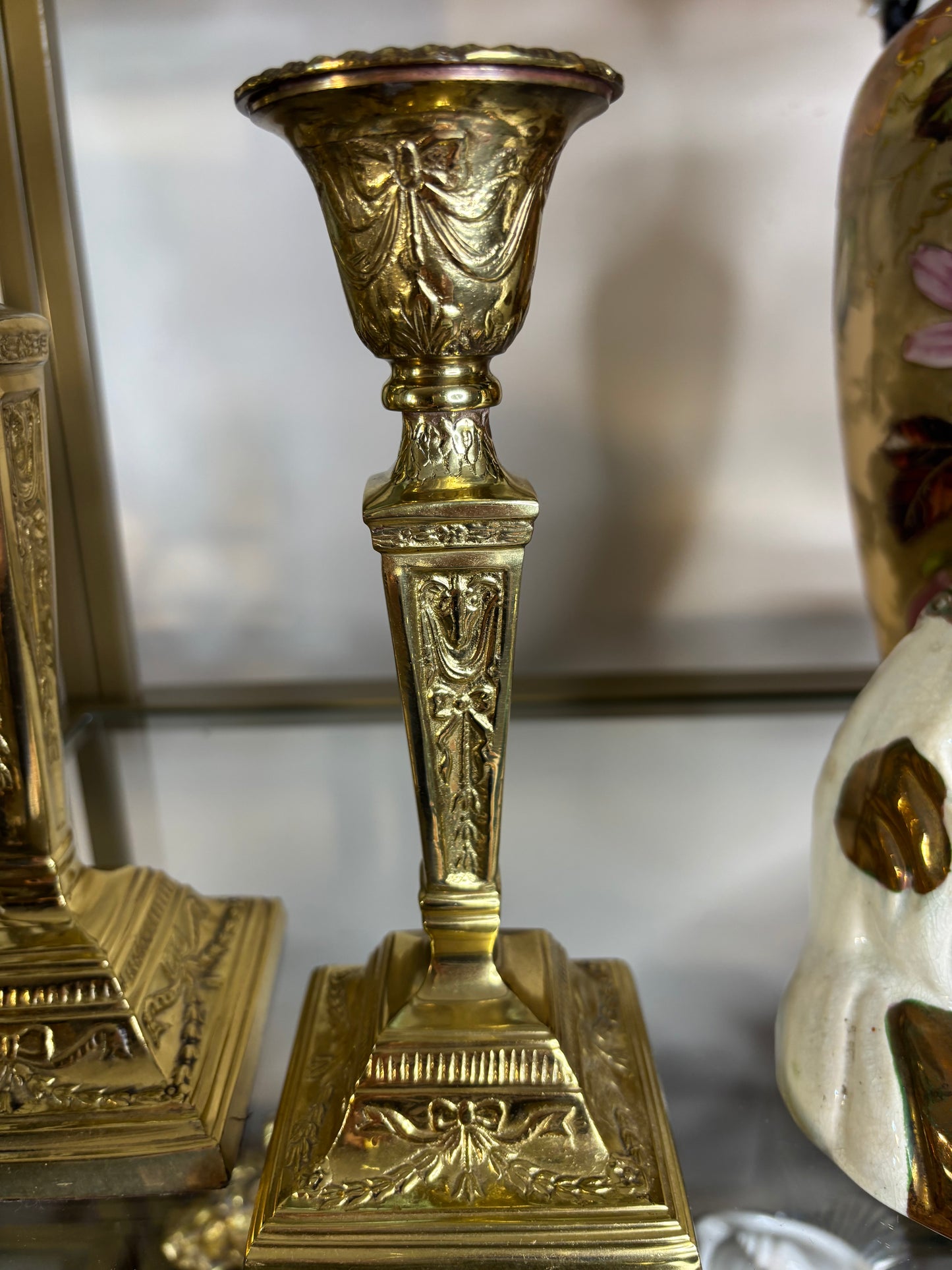 Beautiful brass candleholders pair featuring bows and ribbon designs!