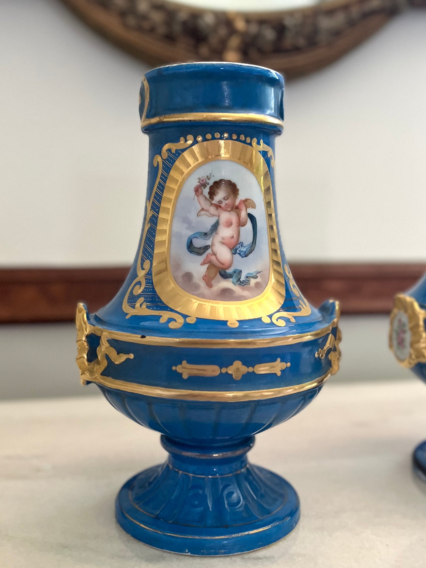 Elegant Pair of Antique 19th Century French Sèvres Style Porcelain Vases In Céleste Bleu With Hand-Painted Putti And Florals