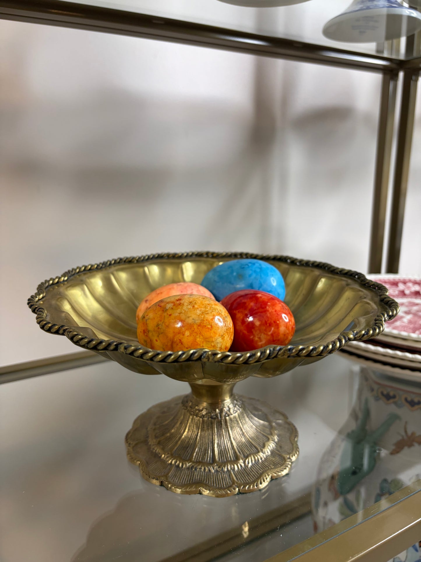 Beautiful brass scalloped pedestal bowl with rope design and intricate base! Includes four alabaster eggs!