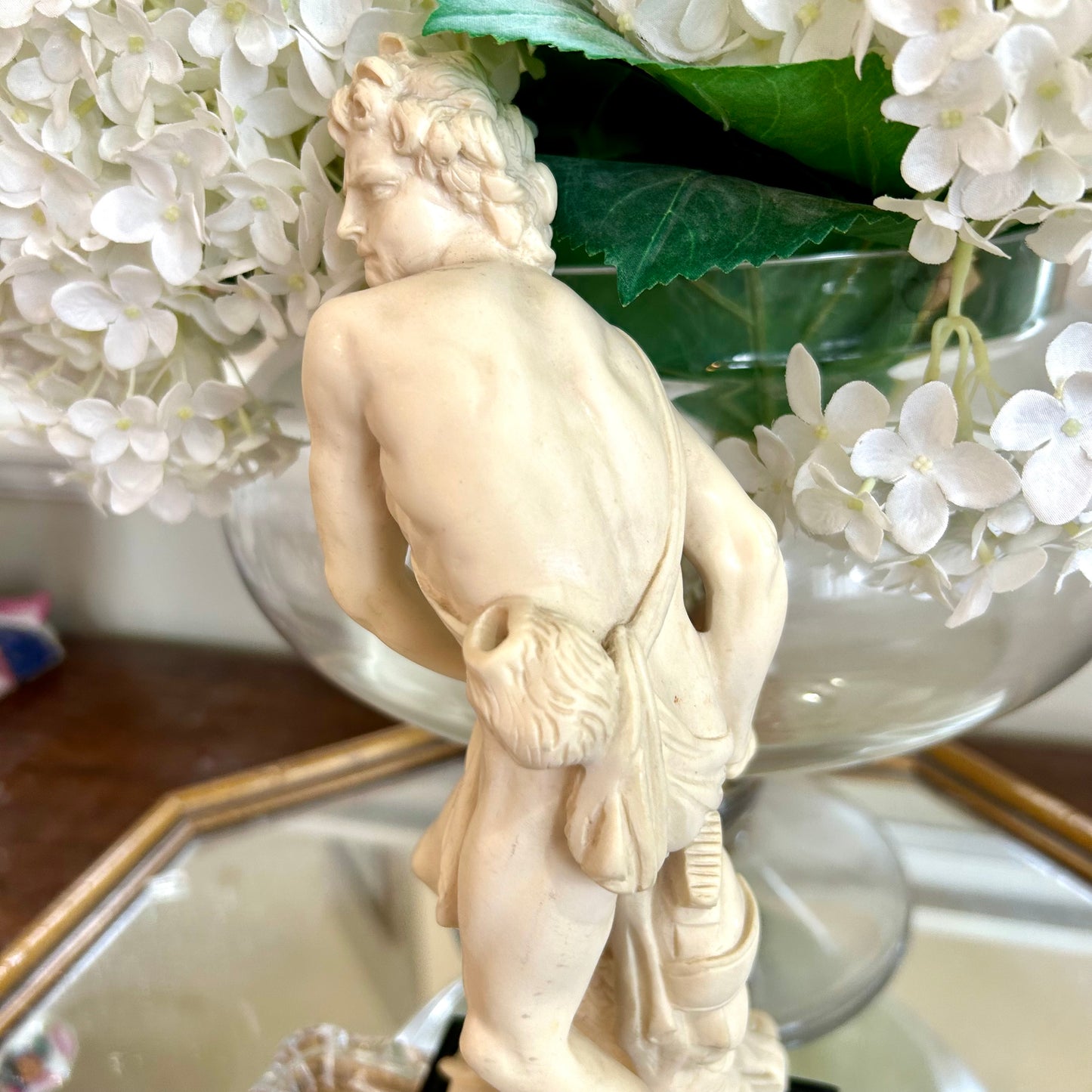 Neoclassical inspired masculine hunter vintage statue in pedestal.