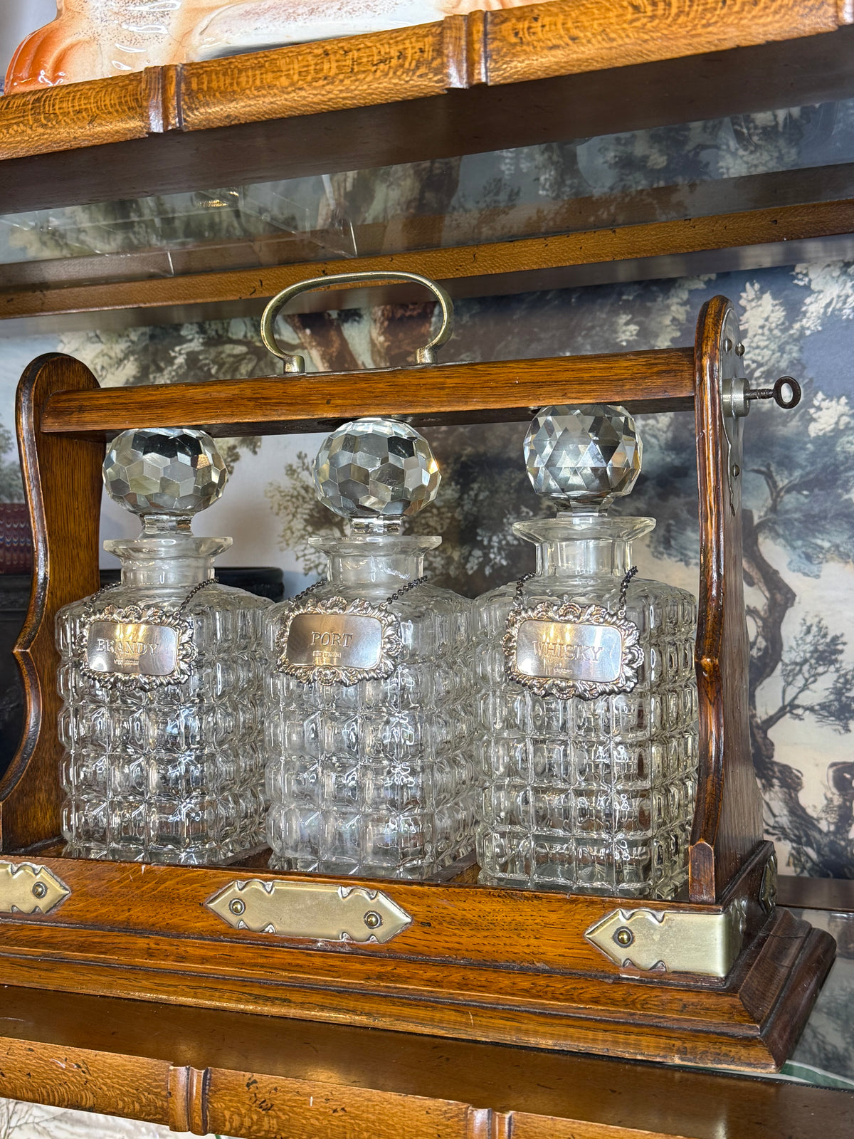 Antique English Oak Three-Bottle Tantalus W/ Cut Crystal Decanters, Sterling Silver Labels & Original Key, c.1900, 15” W x 13” H x 6.5” D