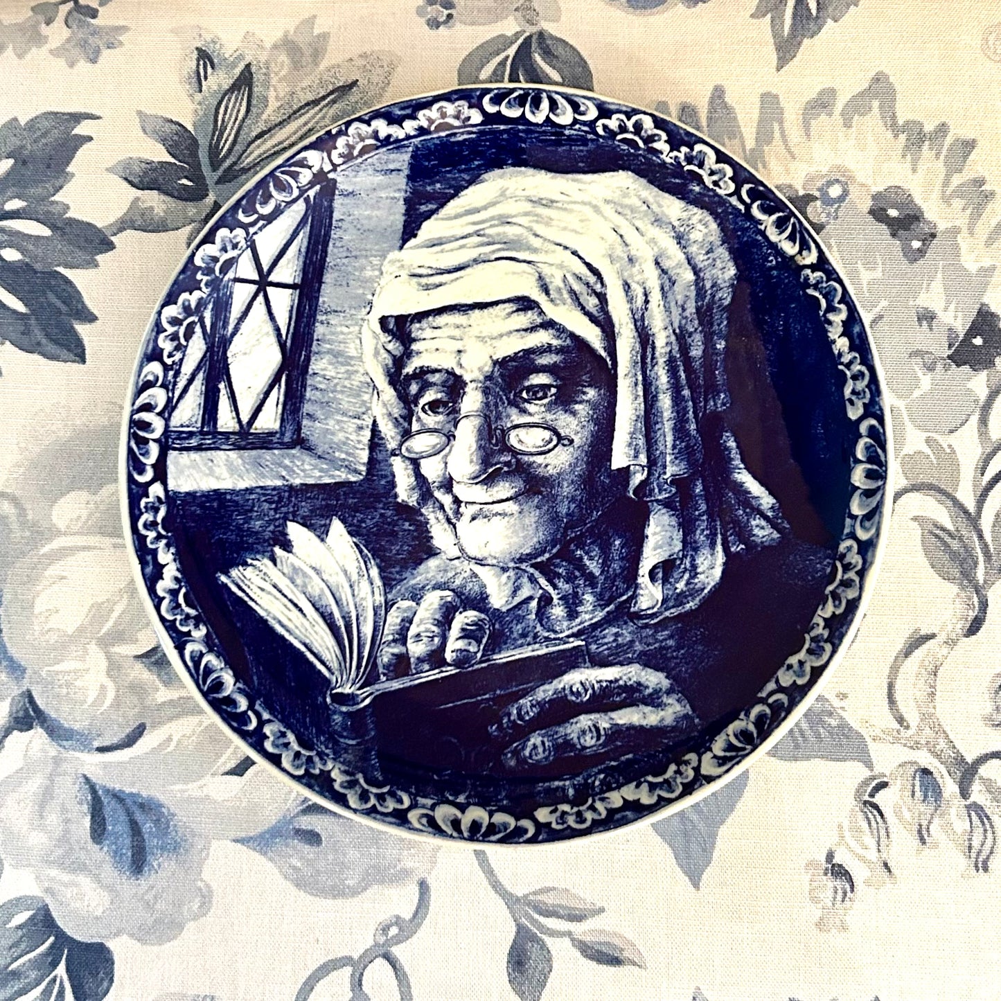 Lovely woman reading hand painted vintage Delft of Holland blue and white plate