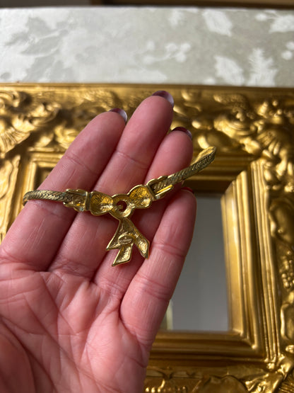 Stunning vintage Givenchy gold plated herringbone chain necklace with a crystal bow pendant!