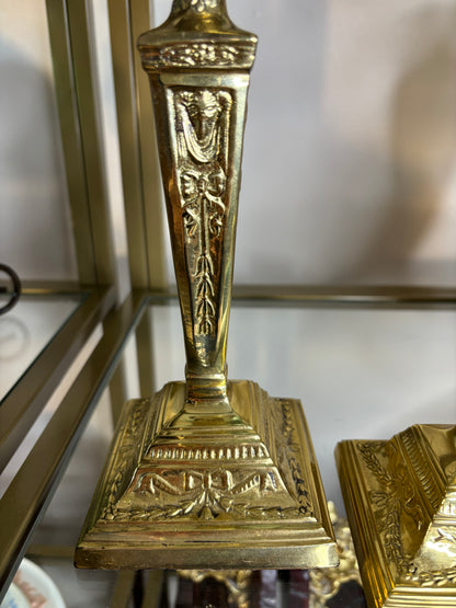 Beautiful brass candleholders pair featuring bows and ribbon designs!