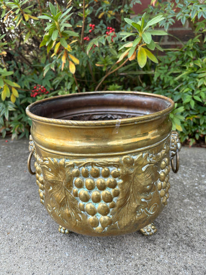 Beautiful large brass planter with grape vine motif, Lion handles, and claw feet! As is!