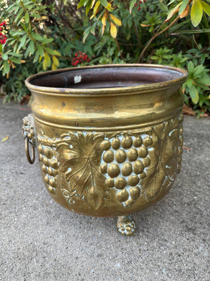 Beautiful large brass planter with grape vine motif, Lion handles, and claw feet! As is!