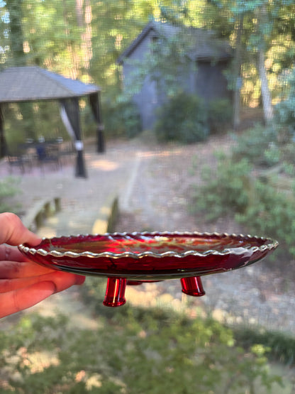 Beautiful red glass footed dish with silver florals and scalloped rim!