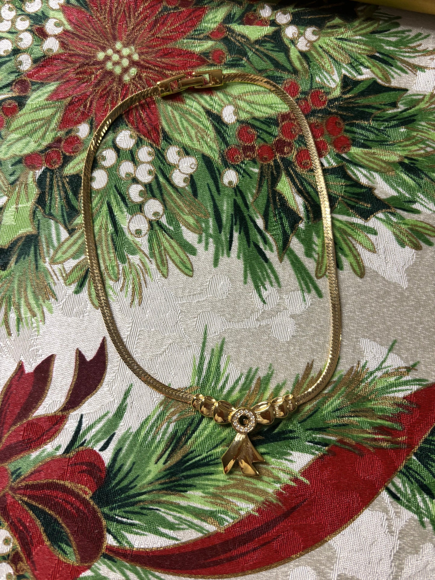 Stunning vintage Givenchy gold plated herringbone chain necklace with a crystal bow pendant!