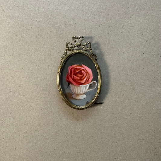Pink peachy rose in white English tea cup
