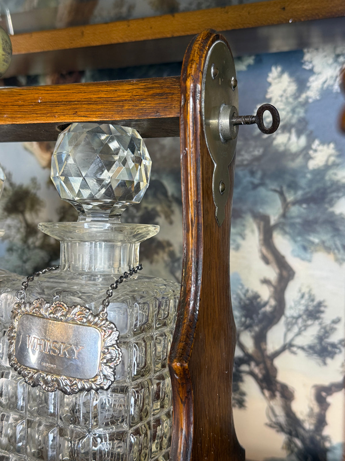 Antique English Oak Three-Bottle Tantalus W/ Cut Crystal Decanters, Sterling Silver Labels & Original Key, c.1900, 15” W x 13” H x 6.5” D
