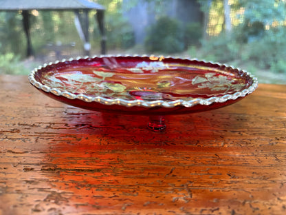 Beautiful red glass footed dish with silver florals and scalloped rim!