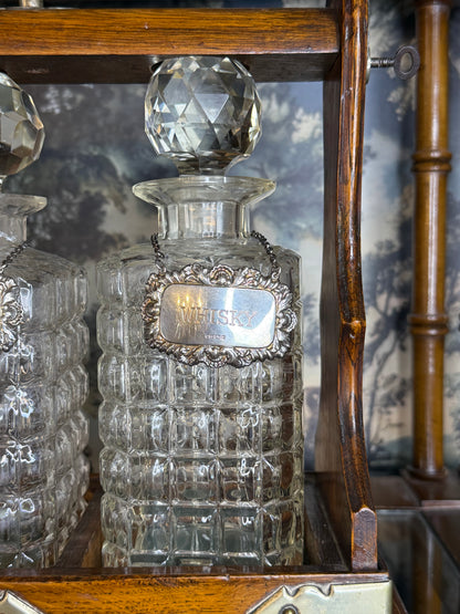Antique English Oak Three-Bottle Tantalus W/ Cut Crystal Decanters, Sterling Silver Labels & Original Key, c.1900, 15” W x 13” H x 6.5” D