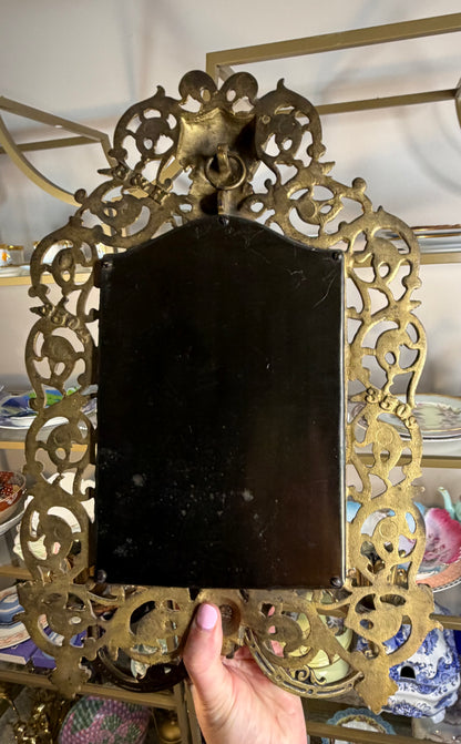 Stunning Bradley & Hubbard antique brass beveled wall mirror featuring a Bacchus figural motif and attached candle sconces!