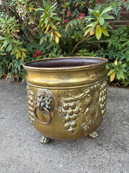 Beautiful large brass planter with grape vine motif, Lion handles, and claw feet! As is!