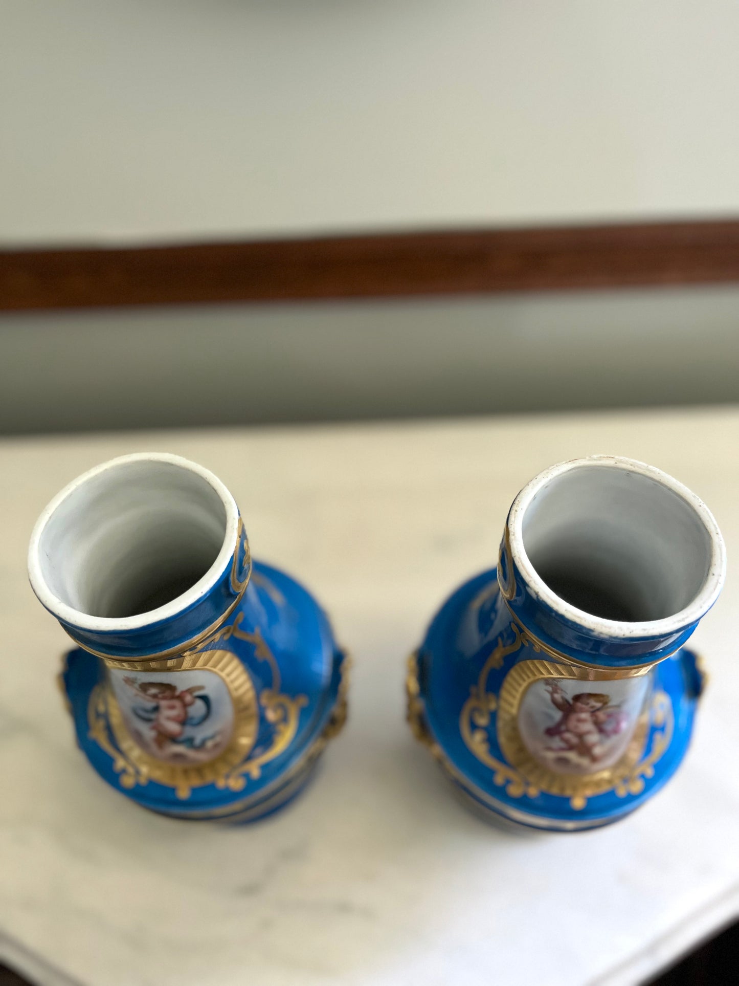 Elegant Pair of Antique 19th Century French Sèvres Style Porcelain Vases In Céleste Bleu With Hand-Painted Putti And Florals