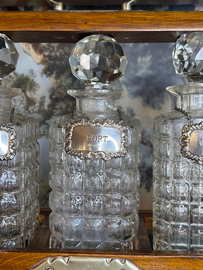 Antique English Oak Three-Bottle Tantalus W/ Cut Crystal Decanters, Sterling Silver Labels & Original Key, c.1900, 15” W x 13” H x 6.5” D