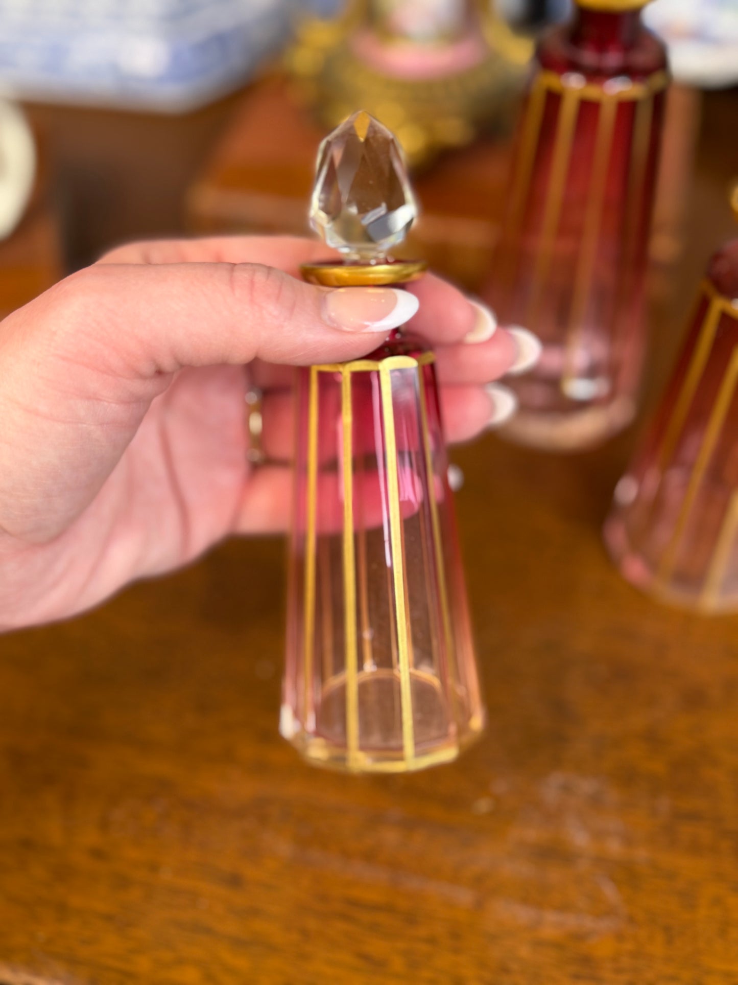 Set of 3 Cranberry Cut Crystal Perfume Bottles with Gilt Detail & Faceted Stoppers, c. 1930s–50s (8.5”, 6.5”, 6”)