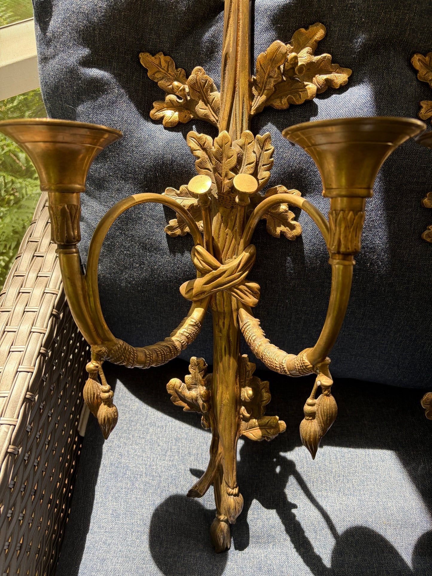Stunning antique pair of French Louis XVI style brass wall sconces with bows, tassels, and horn motif designs!