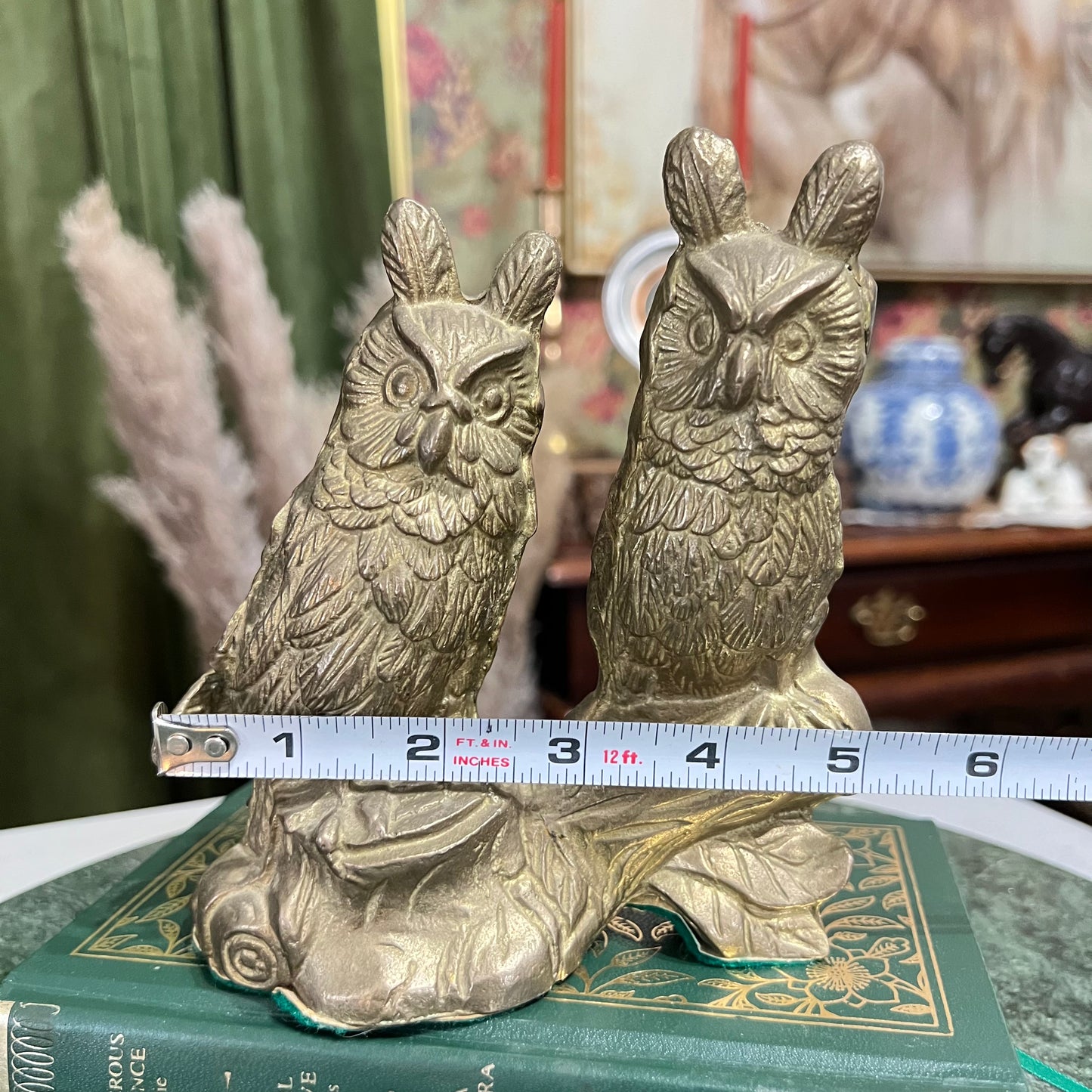Vintage two brass horned owls sitting on a branch