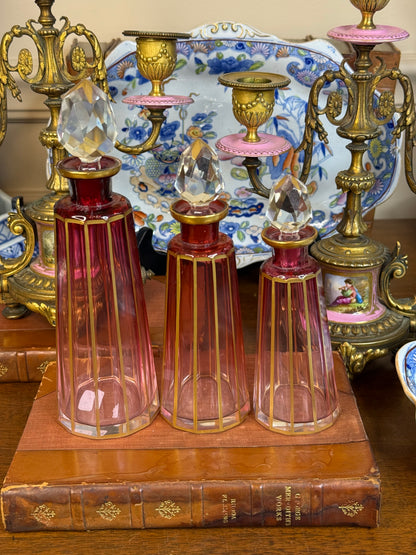 Set of 3 Cranberry Cut Crystal Perfume Bottles with Gilt Detail & Faceted Stoppers, c. 1930s–50s (8.5”, 6.5”, 6”)