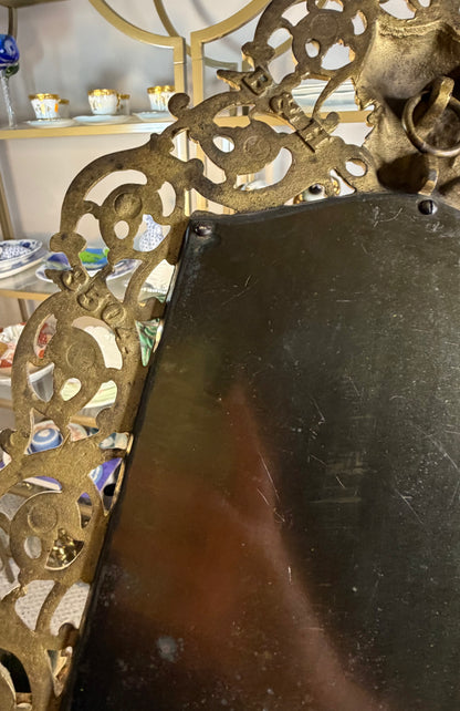 Stunning Bradley & Hubbard antique brass beveled wall mirror featuring a Bacchus figural motif and attached candle sconces!