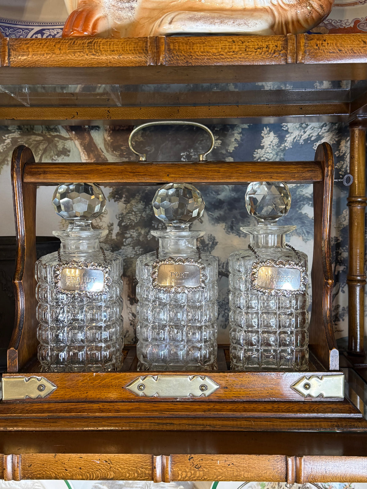 Antique English Oak Three-Bottle Tantalus W/ Cut Crystal Decanters, Sterling Silver Labels & Original Key, c.1900, 15” W x 13” H x 6.5” D