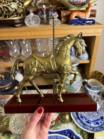 Brass carousel horse on wood!