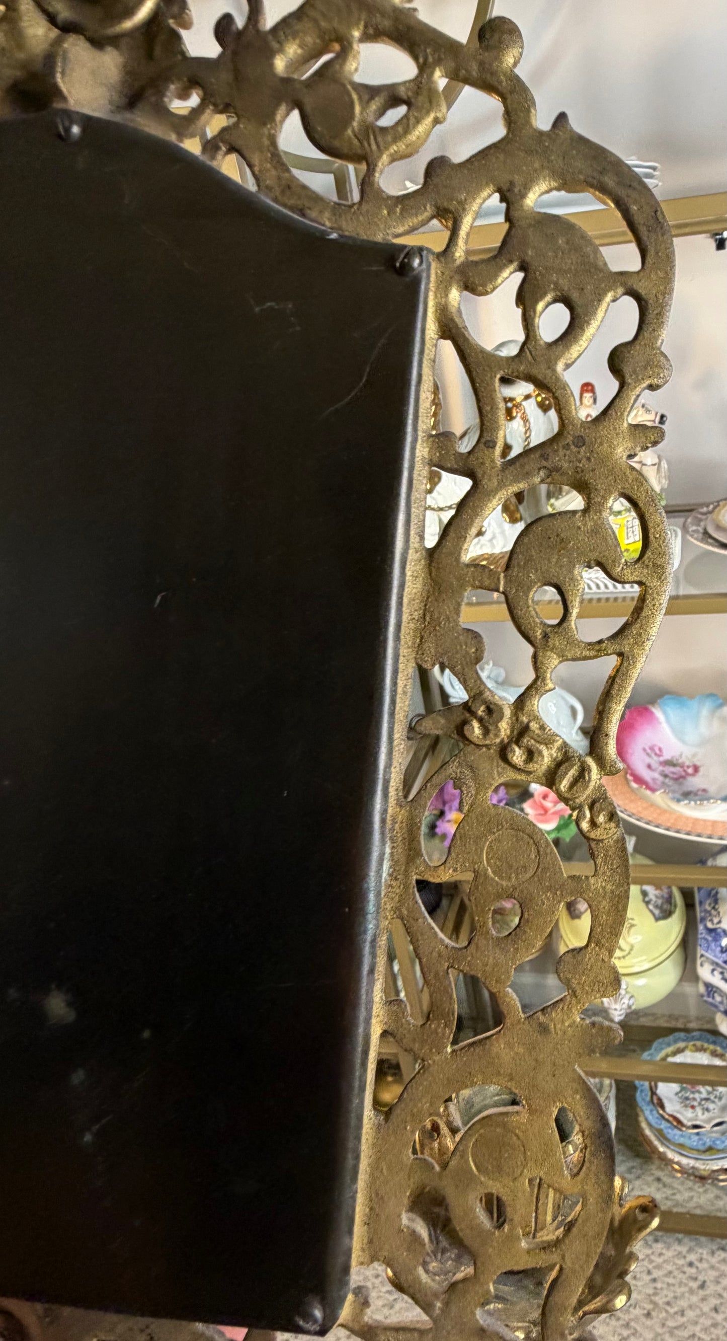 Stunning Bradley & Hubbard antique brass beveled wall mirror featuring a Bacchus figural motif and attached candle sconces!
