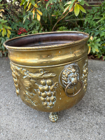 Beautiful large brass planter with grape vine motif, Lion handles, and claw feet! As is!