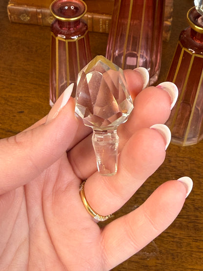 Set of 3 Cranberry Cut Crystal Perfume Bottles with Gilt Detail & Faceted Stoppers, c. 1930s–50s (8.5”, 6.5”, 6”)