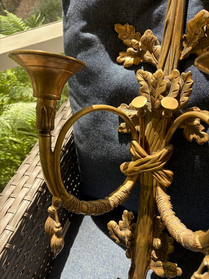 Stunning antique pair of French Louis XVI style brass wall sconces with bows, tassels, and horn motif designs!
