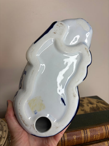 Chinoiserie blue and white resting cat with bow and floral designs!