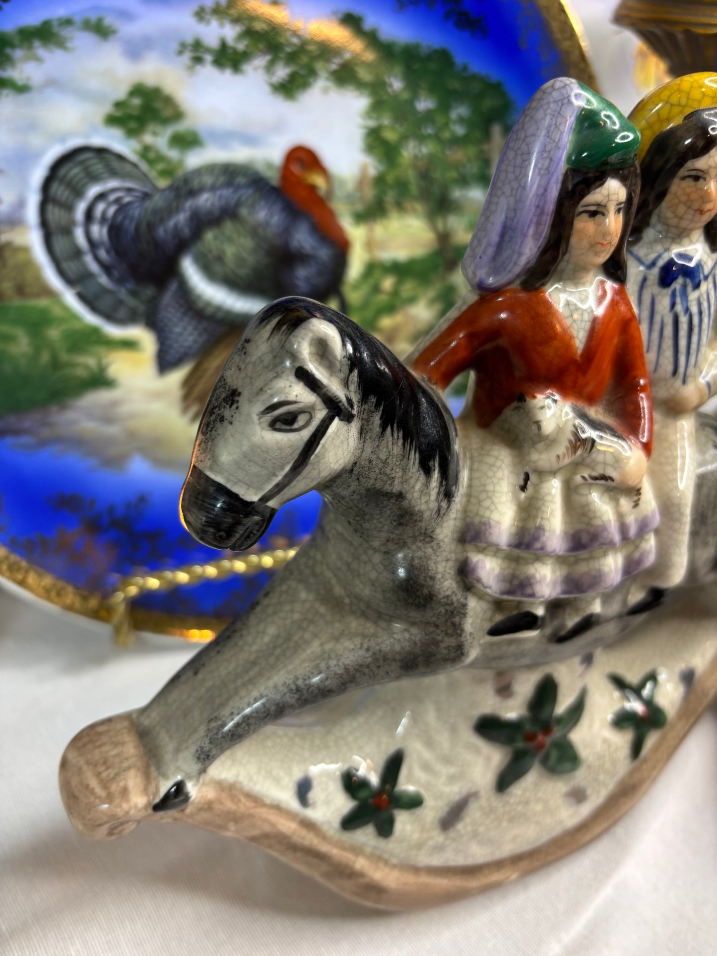 Staffordshire couple on rocking horse!
