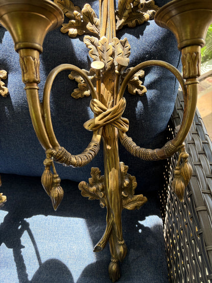 Stunning antique pair of French Louis XVI style brass wall sconces with bows, tassels, and horn motif designs!