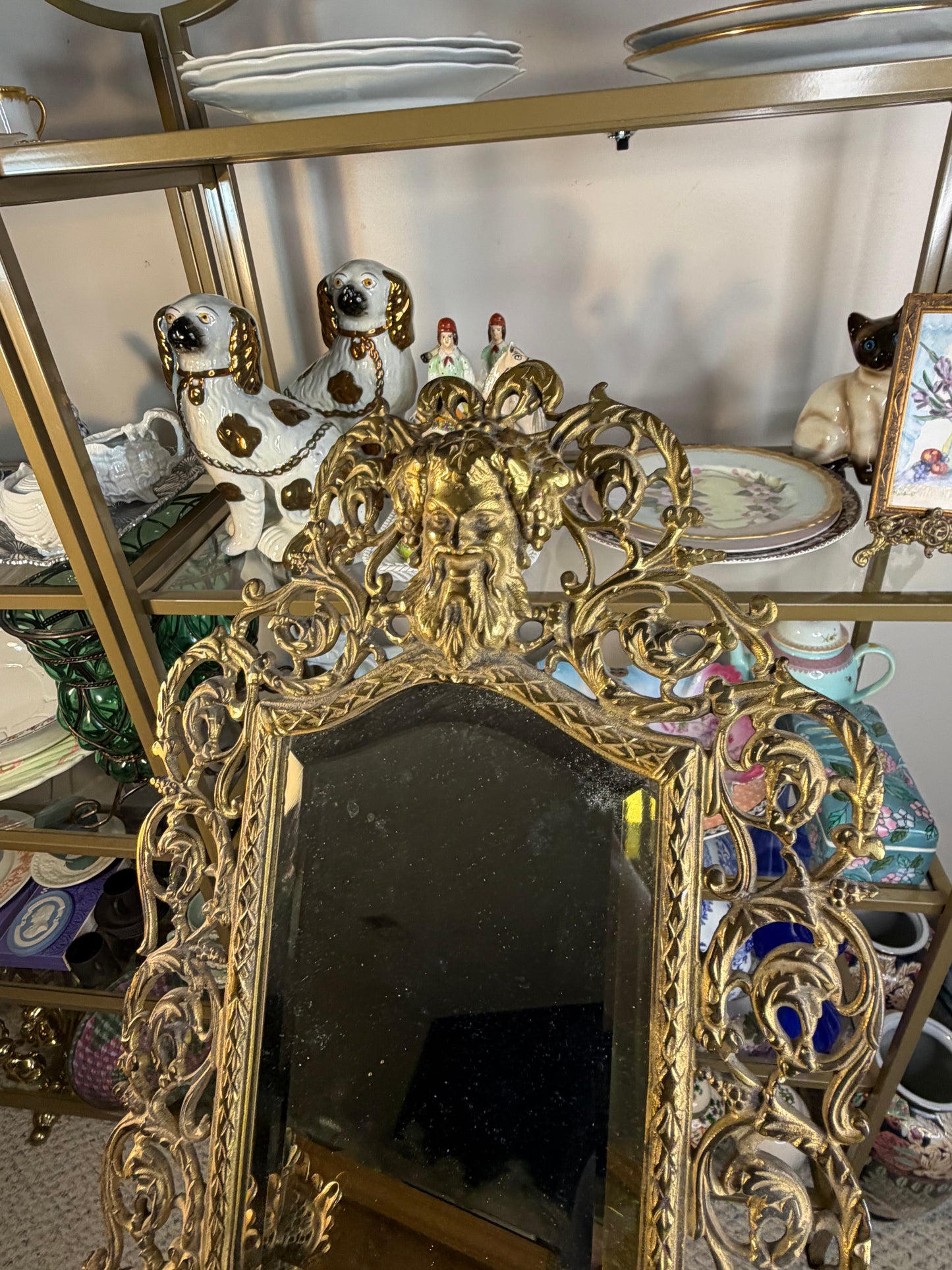 Stunning Bradley & Hubbard antique brass beveled wall mirror featuring a Bacchus figural motif and attached candle sconces!