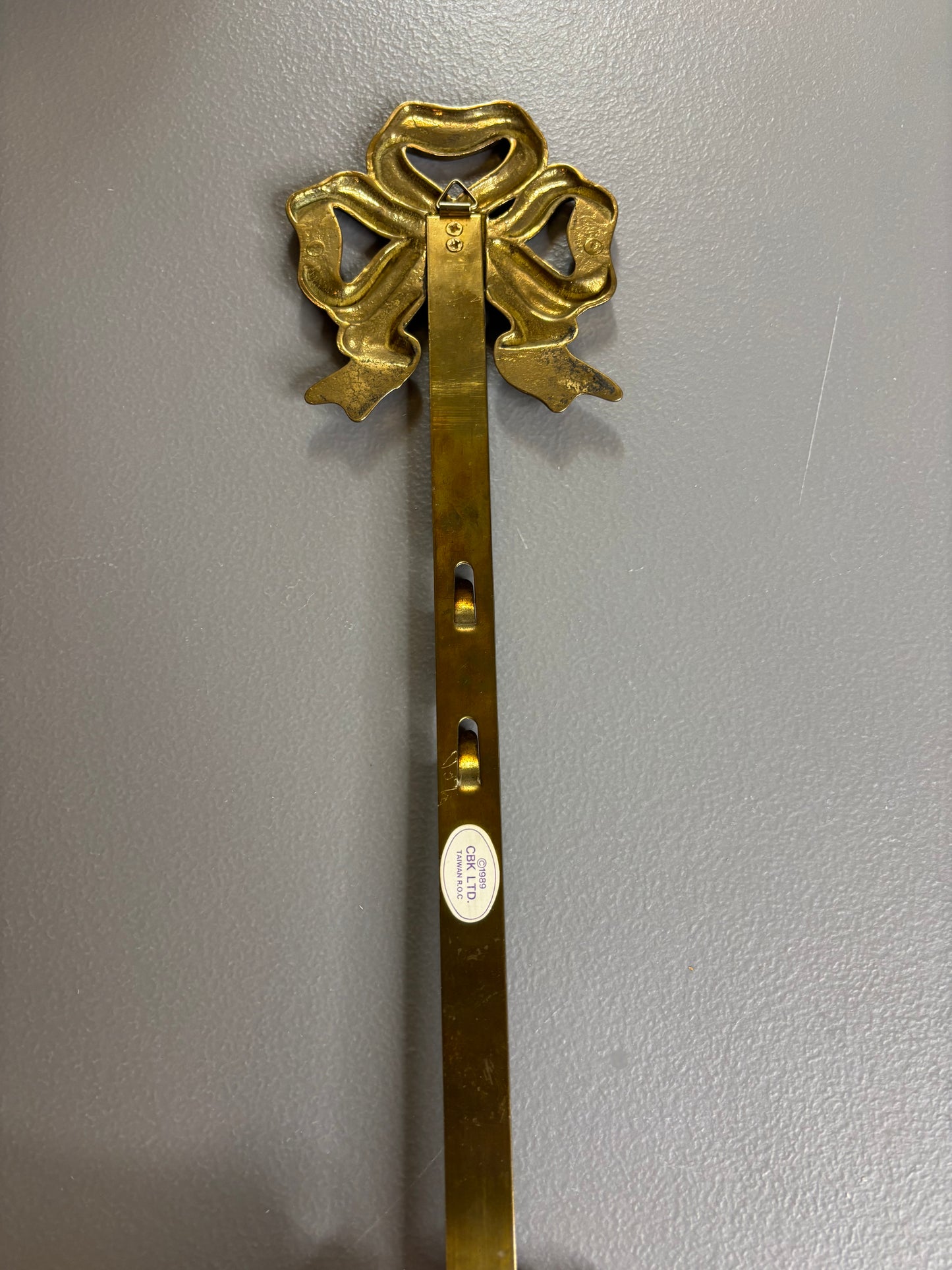 Vintage brass bow and tassel wall plate hanger!