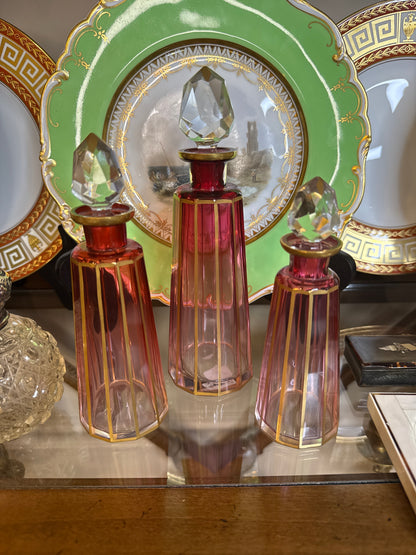 Set of 3 Cranberry Cut Crystal Perfume Bottles with Gilt Detail & Faceted Stoppers, c. 1930s–50s (8.5”, 6.5”, 6”)