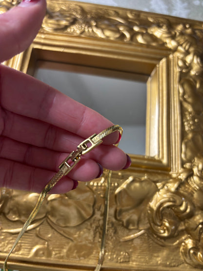 Stunning vintage Givenchy gold plated herringbone chain necklace with a crystal bow pendant!