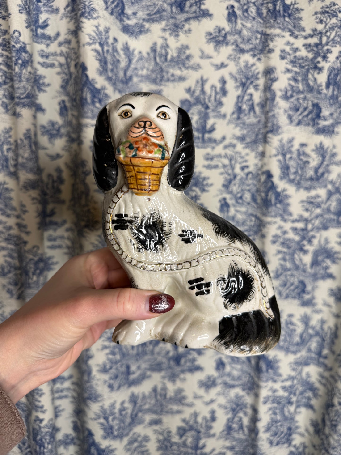 RESERVED - DA4257 - Staffordshire figure of a black and white dog holding a basket of flowers