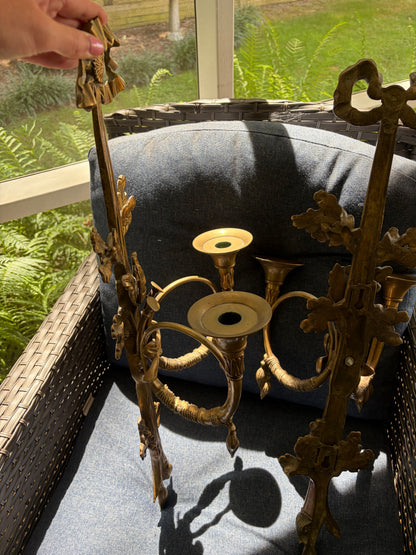 Stunning antique pair of French Louis XVI style brass wall sconces with bows, tassels, and horn motif designs!