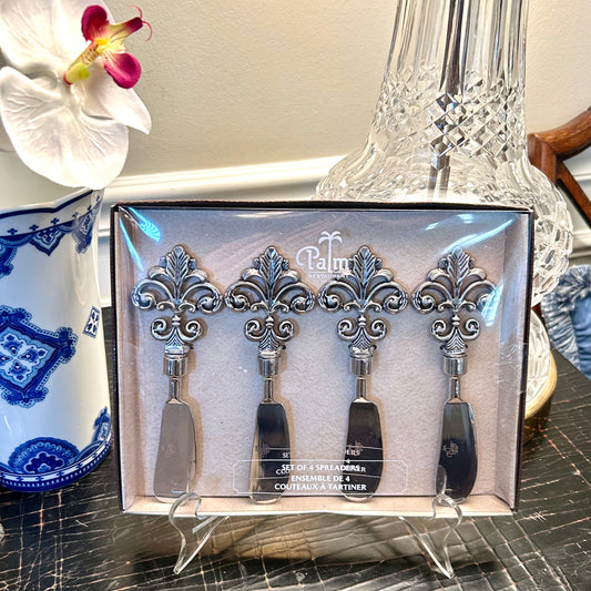 set of four New in box silver stainless cheese knives or spreaders  .