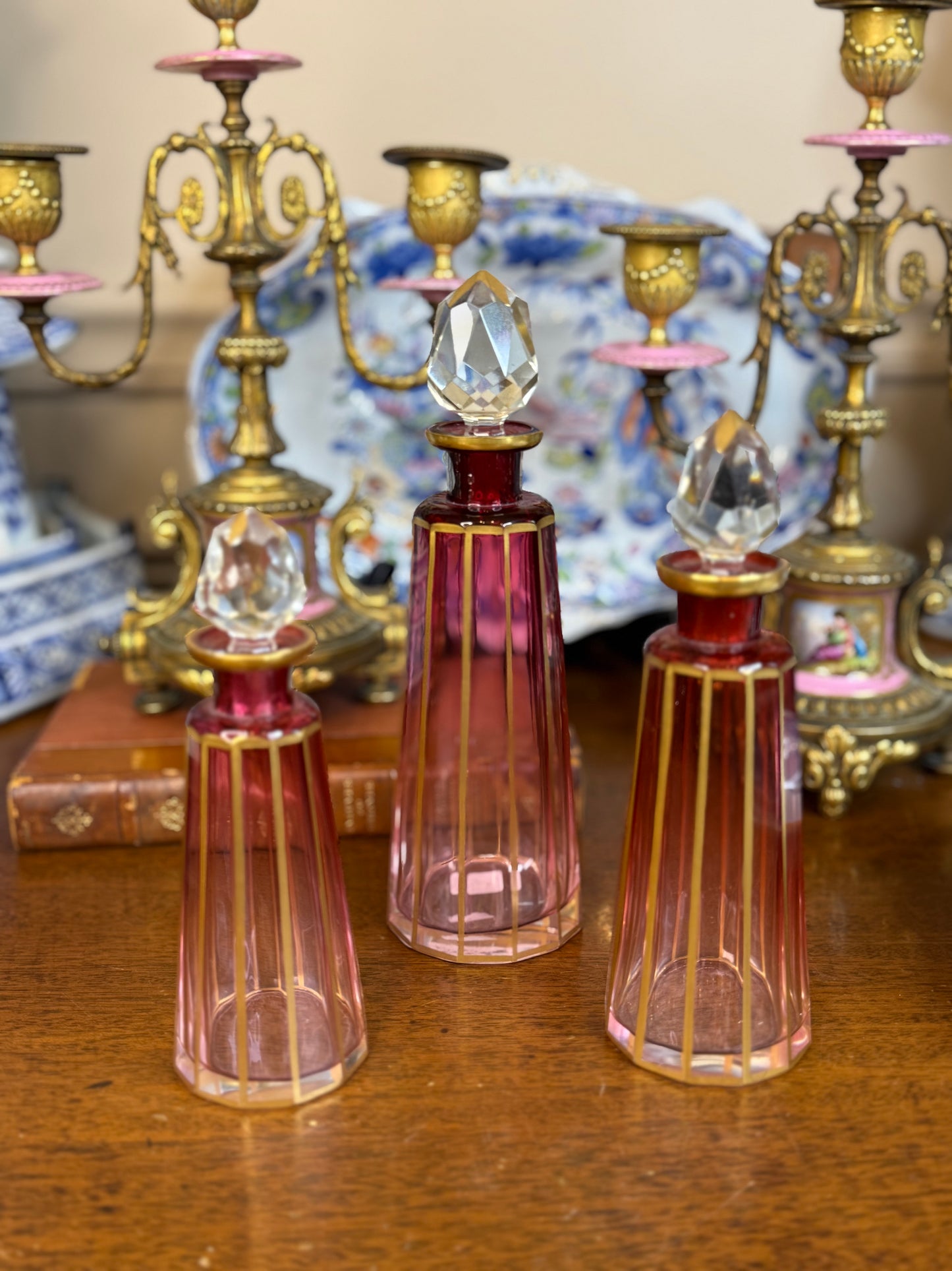 Set of 3 Cranberry Cut Crystal Perfume Bottles with Gilt Detail & Faceted Stoppers, c. 1930s–50s (8.5”, 6.5”, 6”)