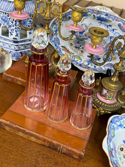 Set of 3 Cranberry Cut Crystal Perfume Bottles with Gilt Detail & Faceted Stoppers, c. 1930s–50s (8.5”, 6.5”, 6”)