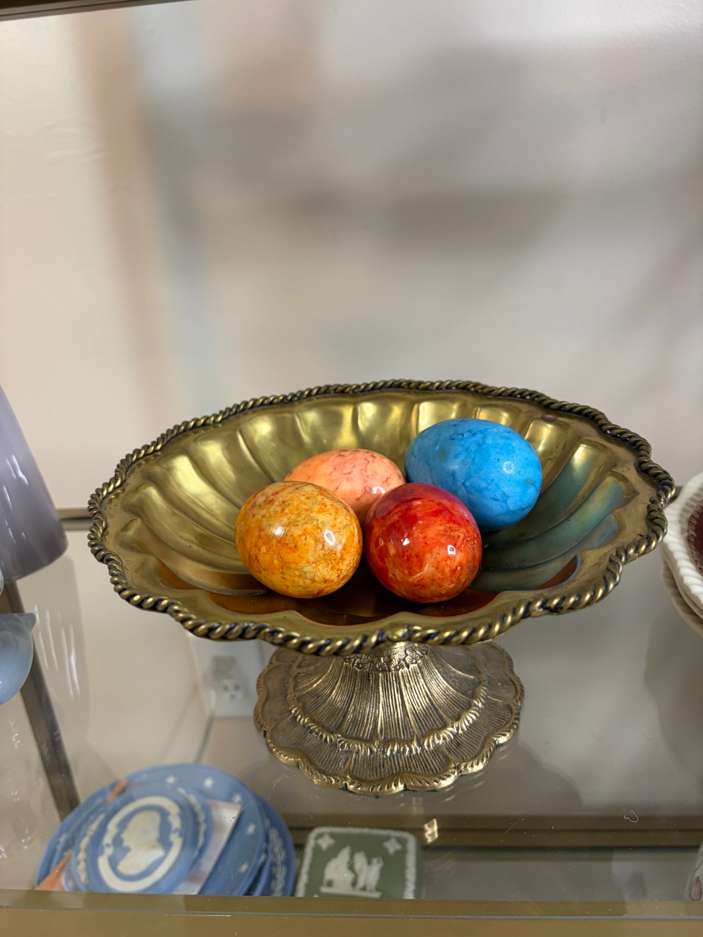 Beautiful brass scalloped pedestal bowl with rope design and intricate base! Includes four alabaster eggs!