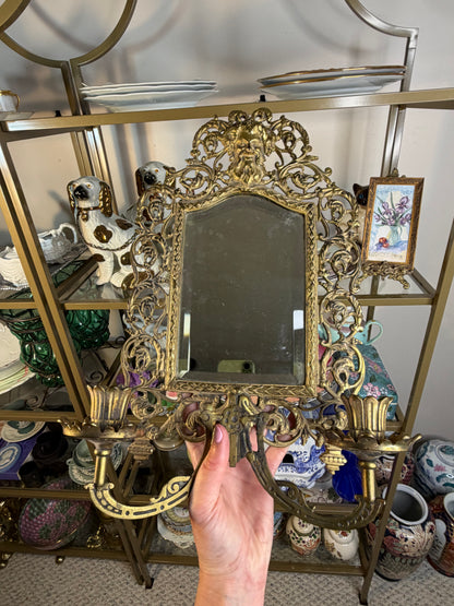 Stunning Bradley & Hubbard antique brass beveled wall mirror featuring a Bacchus figural motif and attached candle sconces!
