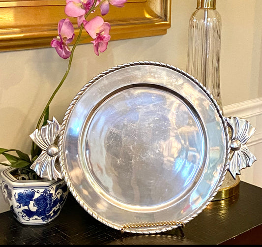 Vintage large round silver shade platter with big bow handle details.