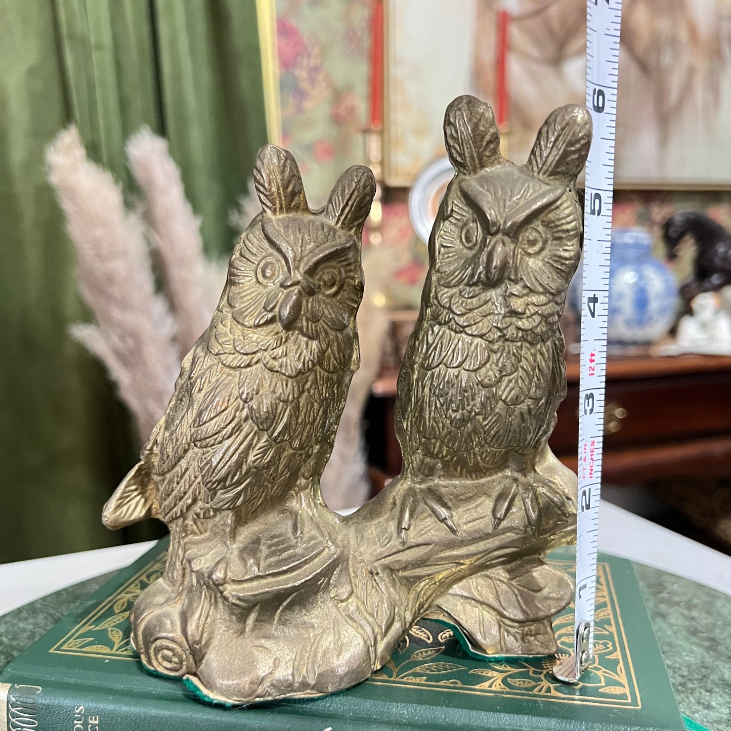 Vintage two brass horned owls sitting on a branch